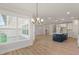Open living space features an island kitchen, hardwood floors, and great natural light at 1306 Cricket St, Elon, NC 27244