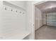 Hallway mudroom area with a bench and coat hooks leading into the garage at 1306 Cricket St, Elon, NC 27244