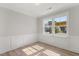 Bright office with natural light, wood floors and wainscoting with view to neighborhood at 1306 Cricket St, Elon, NC 27244