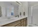 Bathroom featuring double sink vanity, framed mirrors, and glass shower doors at 133 Pasadena Rd, Garner, NC 27529