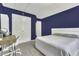 Bedroom featuring navy walls, plush carpet, and a white bed with a padded headboard at 133 Pasadena Rd, Garner, NC 27529
