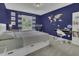 Bedroom with cool blue walls, world map art, and a bookcase by the bed at 133 Pasadena Rd, Garner, NC 27529