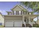 Charming two-story home with a welcoming front porch, attached two-car garage, and traditional siding details at 133 Pasadena Rd, Garner, NC 27529