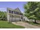 Charming two-story home with a well-manicured lawn, basketball hoop, and mature trees at 133 Pasadena Rd, Garner, NC 27529