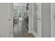 Hallway leading to a kitchen with stainless steel refrigerator and breakfast nook at 133 Pasadena Rd, Garner, NC 27529