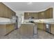 Open kitchen featuring granite countertops, stainless steel appliances, and an island with seating at 133 Pasadena Rd, Garner, NC 27529