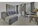 Comfortable living room with a plush gray sectional sofa, a desk, and natural light at 133 Pasadena Rd, Garner, NC 27529