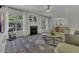 Inviting living room with fireplace, carpet, and large windows that let in lots of natural light at 133 Pasadena Rd, Garner, NC 27529