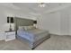 Spacious main bedroom with a luxurious tufted headboard and a cozy sitting area at 133 Pasadena Rd, Garner, NC 27529