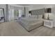 Spacious main bedroom with a luxurious tufted headboard and a cozy sitting area at 133 Pasadena Rd, Garner, NC 27529