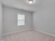 Minimalist bedroom with soft carpet and a large window, offering a simple and relaxing space at 138 Yellow Jacket Rdg, Clayton, NC 27520