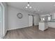 Open-concept kitchen area with hardwood floors, a sliding barn door, and a granite island at 138 Yellow Jacket Rdg, Clayton, NC 27520