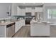 Stylish kitchen showcasing stainless steel appliances, a granite island, and white cabinetry at 138 Yellow Jacket Rdg, Clayton, NC 27520