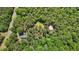 Aerial view of the property, showing the house, building, and the surrounding foliage at 1414 Walter Bright Rd, Sanford, NC 27330