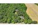 Drone shot of the home, buildings, and property surrounded by green trees and fields at 1414 Walter Bright Rd, Sanford, NC 27330