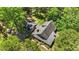 Aerial view of the home and outbuildings surrounded by trees, showcasing its private setting at 1414 Walter Bright Rd, Sanford, NC 27330