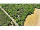 Aerial view of the home and surrounding trees showing a private location with fields at 1414 Walter Bright Rd, Sanford, NC 27330