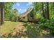 Backyard view showcasing the deck, trees, and house exterior at 1414 Walter Bright Rd, Sanford, NC 27330
