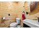 Cozy bathroom featuring wooden paneling, modern fixtures, and a round mirror at 1414 Walter Bright Rd, Sanford, NC 27330