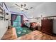 Bedroom with hardwood floors, featuring a ceiling fan and access to an outdoor balcony at 1414 Walter Bright Rd, Sanford, NC 27330