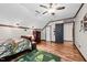 Bright bedroom featuring wood floors, a ceiling fan, and a paw print rug at 1414 Walter Bright Rd, Sanford, NC 27330