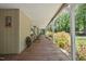 Inviting covered porch with wooden flooring, rustic decor, and comfortable seating at 1414 Walter Bright Rd, Sanford, NC 27330