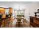 Bright dining area featuring hardwood floors, a dining table, and natural light from the surrounding windows at 1414 Walter Bright Rd, Sanford, NC 27330