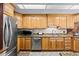 Modern kitchen featuring stainless steel appliances, granite countertops, and classic wood cabinetry at 1414 Walter Bright Rd, Sanford, NC 27330