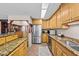 Spacious kitchen with stainless steel refrigerator, granite countertops, and ample wood cabinetry at 1414 Walter Bright Rd, Sanford, NC 27330