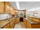 Well-lit kitchen featuring wooden cabinets, granite countertops, stainless steel appliances, and mosaic tile accents at 1414 Walter Bright Rd, Sanford, NC 27330