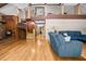 Open-concept living room with hardwood floors, rustic wood accents, spiral stairs, and a comfortable blue sofa at 1414 Walter Bright Rd, Sanford, NC 27330