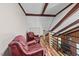 Loft area with wooden beams and railing, perfect for relaxation with comfortable seating at 1414 Walter Bright Rd, Sanford, NC 27330