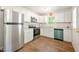 Modern kitchen with stainless steel appliances, white cabinetry, and updated countertops at 145 Mark St, Franklinton, NC 27525