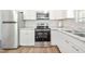 Modern kitchen with stainless steel appliances, white cabinetry, and updated countertops at 145 Mark St, Franklinton, NC 27525