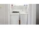 Well-lit laundry room includes a washer, dryer, and shelving at 145 Mark St, Franklinton, NC 27525