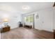 Bright living room featuring wood-look flooring, a large window, and neutral paint at 145 Mark St, Franklinton, NC 27525