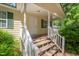 Inviting front porch with white railings and stairs leading to the entrance at 145 Mark St, Franklinton, NC 27525