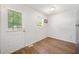 Clean, open room with natural light, wood-look flooring, and an access door at 145 Mark St, Franklinton, NC 27525