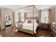 Beautiful bedroom featuring a four-poster bed, hardwood floors, and neutral color scheme at 1601 Glazebrook Dr, Wake Forest, NC 27587