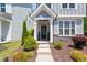 Charming front door with stone accents and well-maintained landscaping at 1601 Glazebrook Dr, Wake Forest, NC 27587