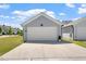 Detached two-car garage with a clean driveway and manicured lawn and landscaping at 1601 Glazebrook Dr, Wake Forest, NC 27587