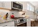 Close-up of a stylish kitchen with stainless steel appliances, decorative backsplash, and granite countertops at 1601 Glazebrook Dr, Wake Forest, NC 27587