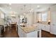 Beautiful kitchen with a large granite island, hardwood floors, and stainless steel appliances adjacent to the dining area at 1601 Glazebrook Dr, Wake Forest, NC 27587