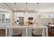Modern kitchen with white cabinetry, granite countertops, stainless steel appliances and a breakfast bar with seating at 1601 Glazebrook Dr, Wake Forest, NC 27587