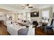 Open-concept living room flows from the kitchen, featuring a fireplace, hardwood floors, and ample natural light at 1601 Glazebrook Dr, Wake Forest, NC 27587