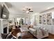 Inviting living room with built-in bookshelves, a fireplace, large windows, and comfortable seating at 1601 Glazebrook Dr, Wake Forest, NC 27587