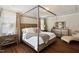 Serene bedroom with hardwood floors, a canopy bed, soft lighting, and neutral decor at 1601 Glazebrook Dr, Wake Forest, NC 27587