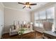 Comfortable home office or den with hardwood floors, a large window, and a relaxing seating area at 1601 Glazebrook Dr, Wake Forest, NC 27587