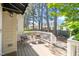 Relaxing back deck features a small table and chairs, and is shaded by mature trees at 1712 Briarforest Pl, Raleigh, NC 27615