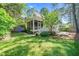 Charming backyard view with a screened in porch and lush green lawn at 1712 Briarforest Pl, Raleigh, NC 27615